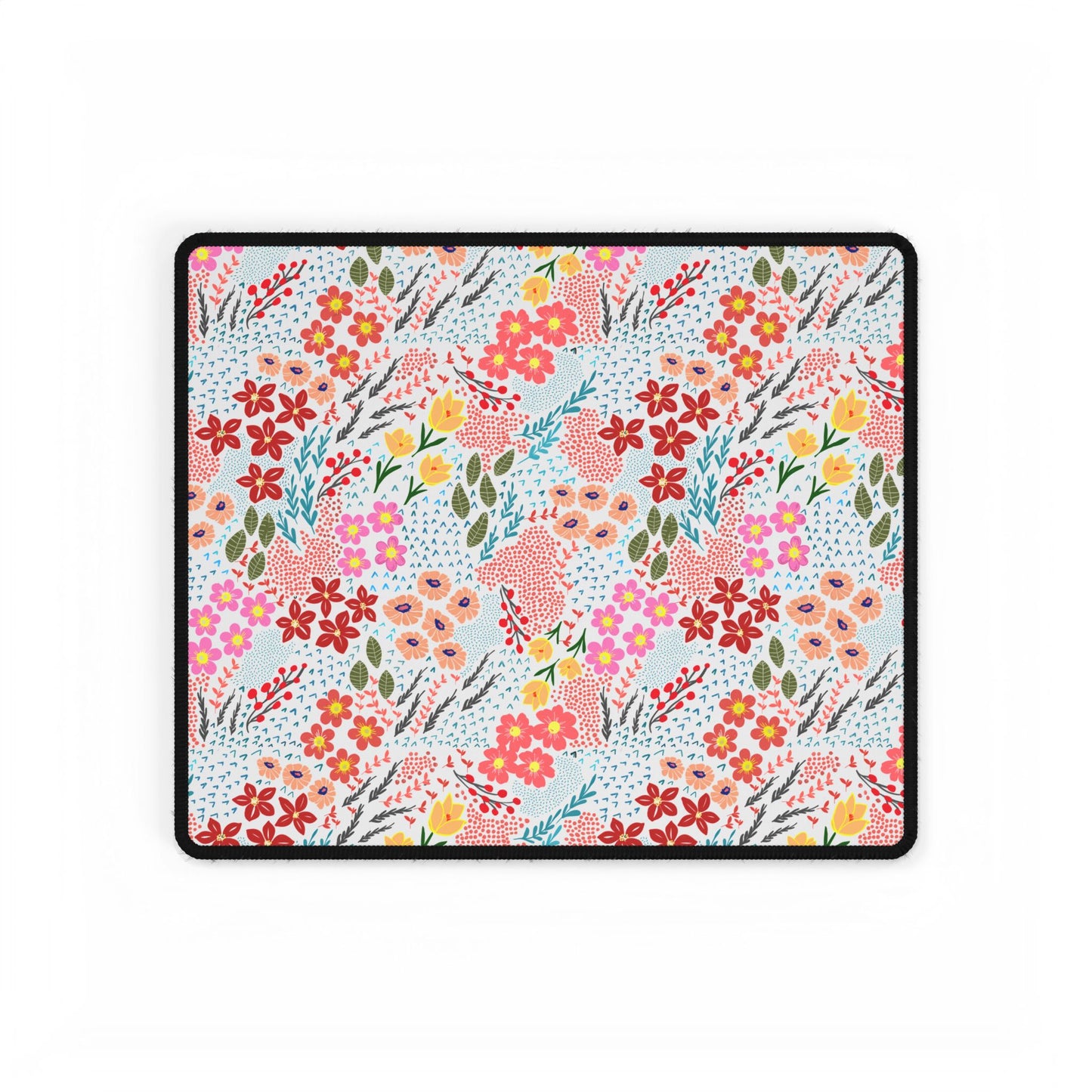 Desk Mats - Garden Floral Pattern features a vibrant floral design with red, pink, peach, and yellow blossoms on a white background, bordered in black stitching, enhancing your workspace with elegance.