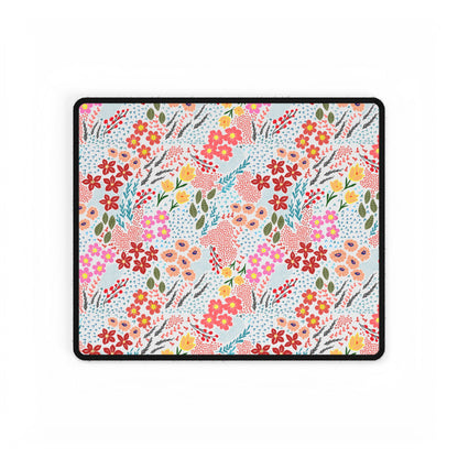 Desk Mats - Garden Floral Pattern features a vibrant floral design with red, pink, peach, and yellow blossoms on a white background, bordered in black stitching, enhancing your workspace with elegance.