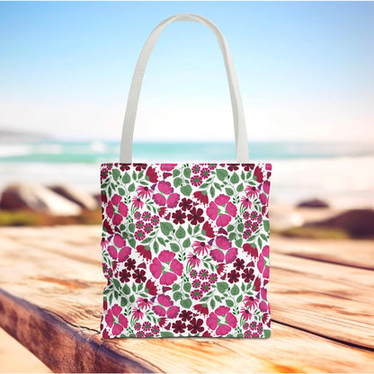 Pink Lady Tote Bag featuring a vibrant pink and burgundy floral pattern on a white canvas, with white handles, ideal for adding a cheerful touch to everyday outings or beach trips.