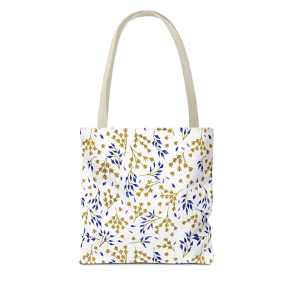 Floral Tote Bag with white body featuring a gold-yellow and blue botanical pattern, beige handles. Ideal for summer outings, reflecting FireBrook Essentials' commitment to uplifting, joyful designs.