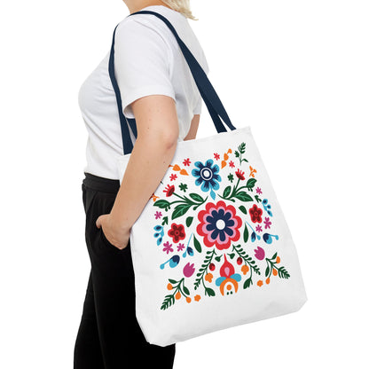 Floral Tote Bag: A woman holds a white tote bag adorned with colorful flowers, showcasing its stylish design and everyday functionality.