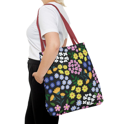 Floral Tote Bag with colorful flower pattern and reddish-maroon straps, worn by a person in casual attire, showcasing FireBrook Designs' vibrant, uplifting style for joyful summer outings.