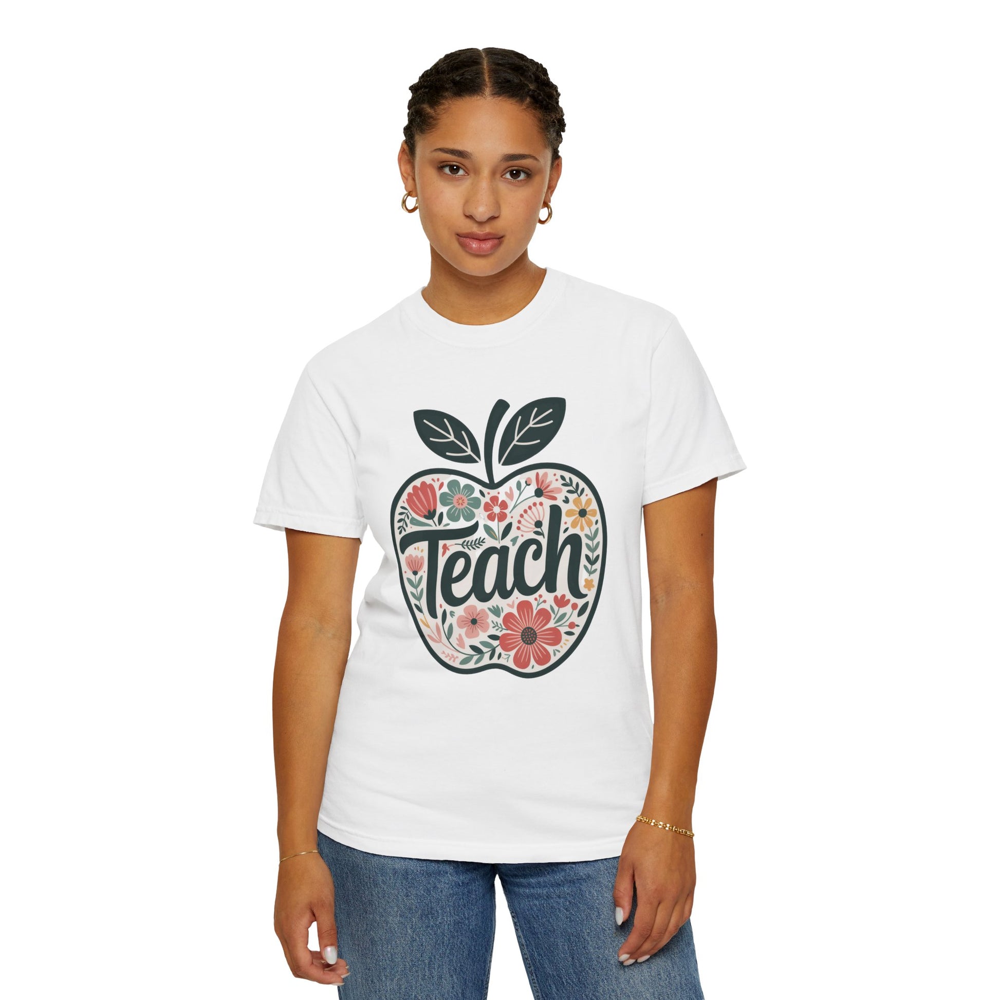 Floral Apple TEACH T-shirt features a large apple with pastel floral design and TEACH text, ideal for educators, embodying FireBrook Essentials' style and positivity.