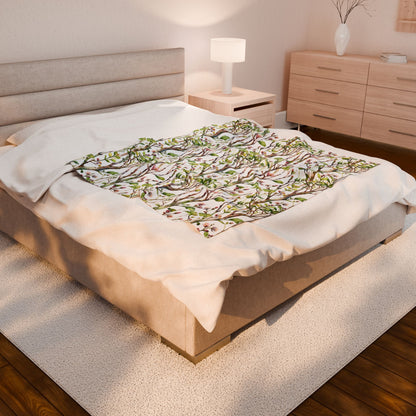 Plush Blanket - Blooming Forest Floor Design, featuring a tree pattern, draped elegantly on a bed, complemented by cozy bedroom decor, embodying FireBrook Essentials' stylish and joyful design ethos.