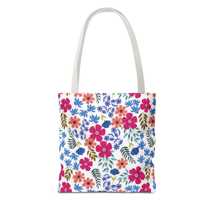 Floral Tote Bag with bright pink, coral, and blue flowers, accented by green and brown foliage on a white background. Featuring long white handles, ideal for vibrant summer outings.
