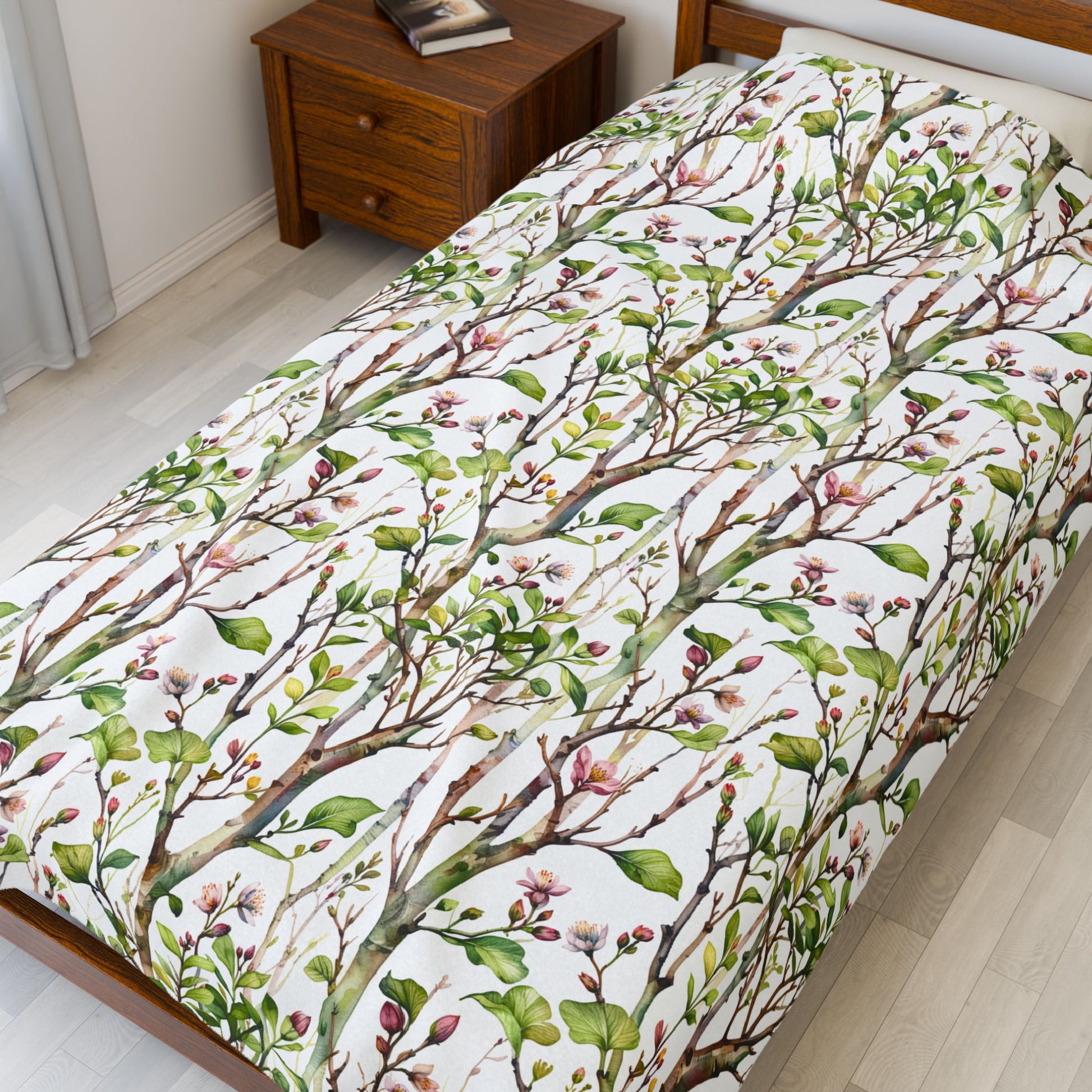 Plush Blanket - Blooming Forest Floor Design, showcasing a serene pattern of budding trees and flowers on a bed, reflecting nature's beauty and comfort, ideal for cozy, nature-inspired relaxation.