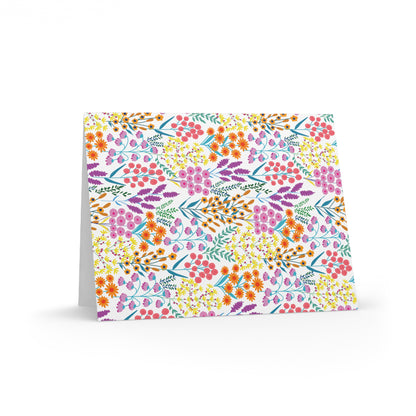 Floral Wildflower Greeting Cards — Pack of 8/16/24 feature a vibrant, hand-drawn floral pattern on a folded card. Ideal for cheerful notes, each card includes a matching white envelope.