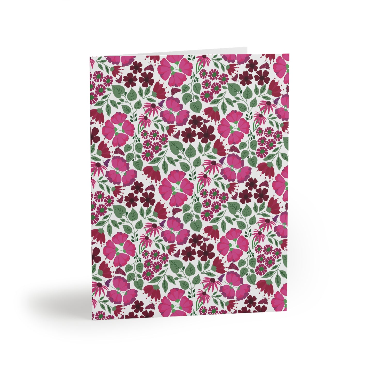 Floral Greeting Cards — Pack of 8/16/24, showcasing a vibrant floral pattern of pink and burgundy blooms with green leaves on a white card, folded and standing upright, embodying cheerful, uplifting design.