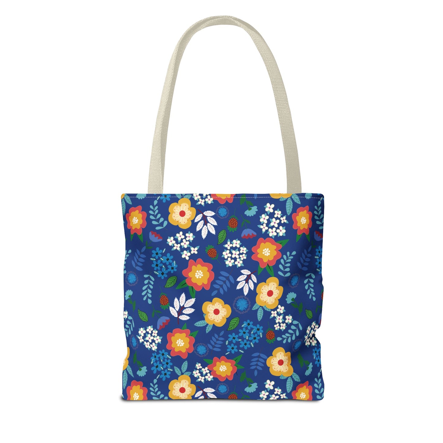 Cornflower Patch Tote Bag features a vivid floral pattern with red, yellow, and white flowers on deep blue. Equipped with natural handles, this durable bag embodies FireBrook Designs' joyful and stylish essence.