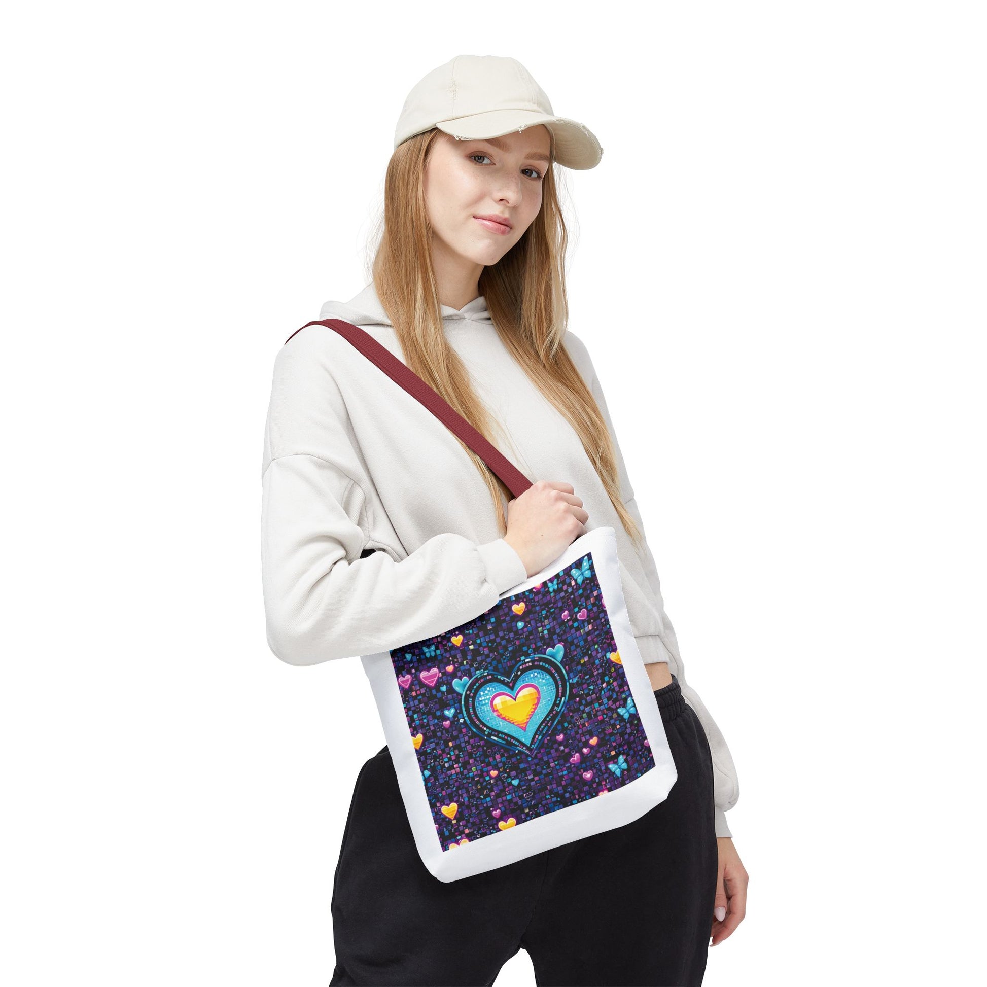Heart Pixelated Nostalgic Cyber-Aesthetic Tote Bag held by a woman in a white hat and sweatshirt, showcasing its unique design with pixelated hearts.
