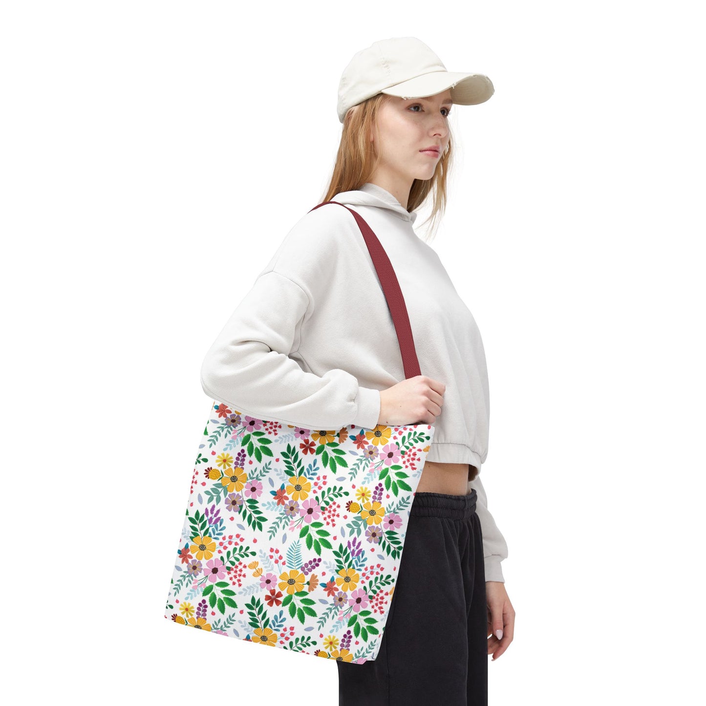 Spring Floral Patch Tote Bag over shoulder, showcasing its bright floral design with burgundy straps, perfect for vibrant, everyday use. Ideal for summer outings and errands, embodying FireBrook Essentials' joyful style.