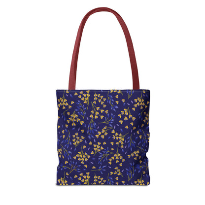 Floral Tote Bag featuring a vibrant botanical pattern of yellow and blue sprigs on navy blue, with burgundy handles. Ideal for summer outings, offering durability and style for joyful adventures.