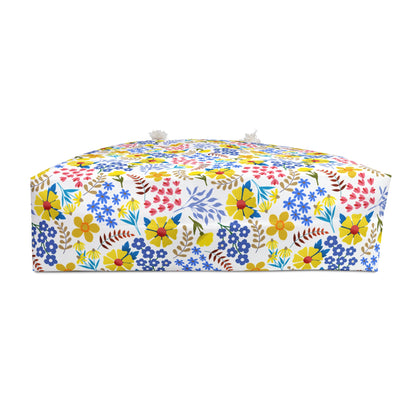 Weekender Bag with bright, multicolored floral pattern and fabric-loop handles, ideal for stylish travel. Designed by FireBrook Essentials to bring comfort and positivity to your journey.