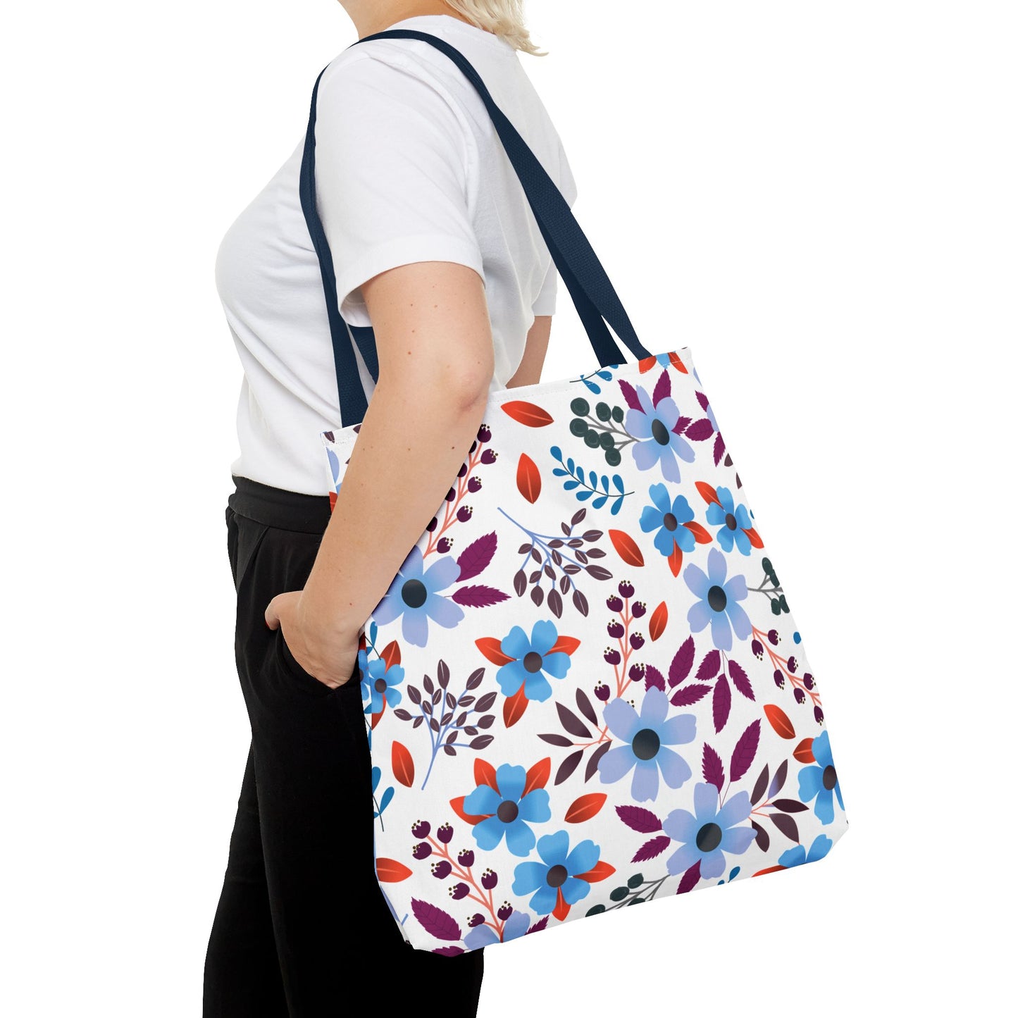 Floral Tote Bag features a vibrant floral print of blue and lavender flowers with red and purple leaves. Perfect for summer outings, it complements FireBrook Designs' joyful, stylish apparel ethos.