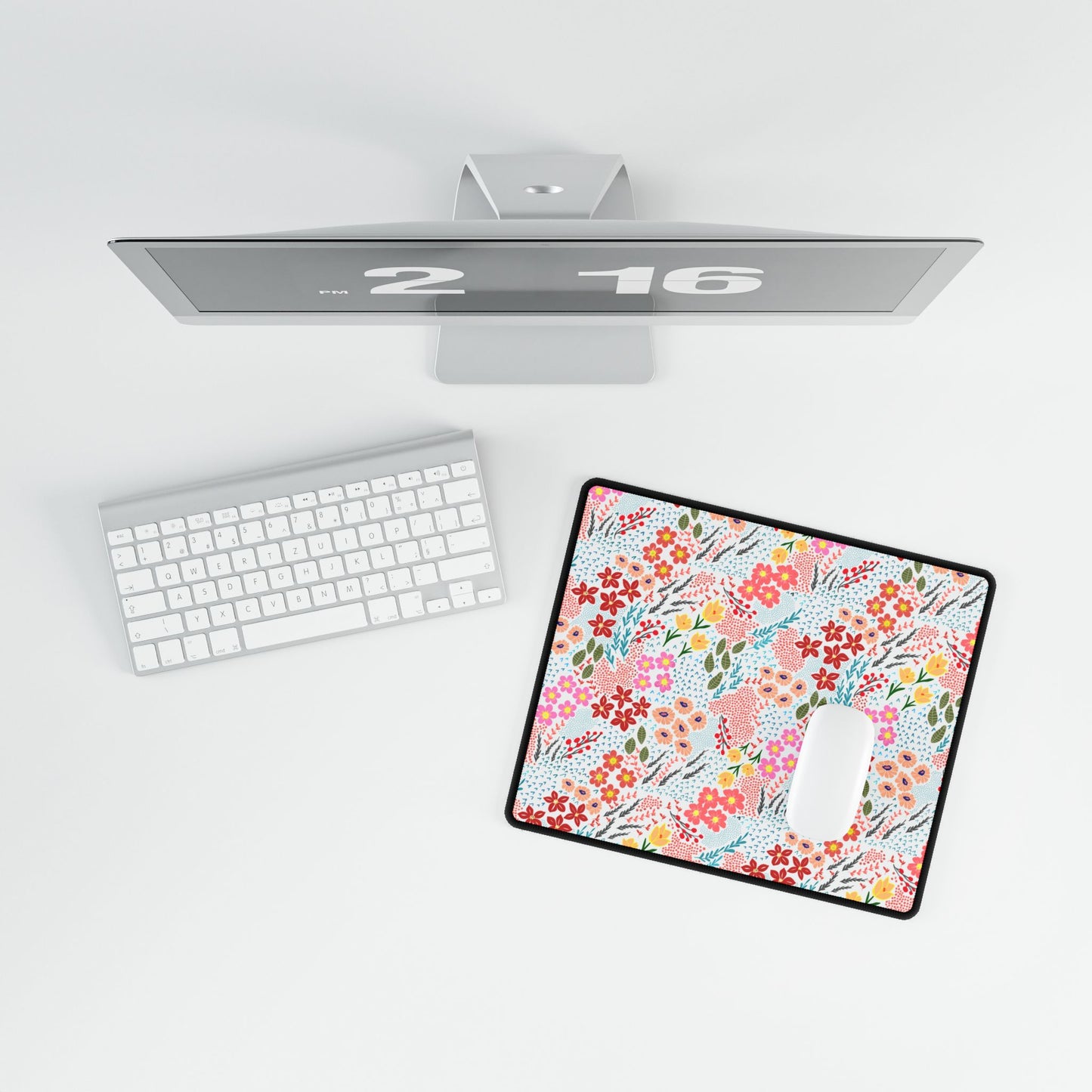 Bird’s-eye view of a minimalist desk featuring the Desk Mat - Garden Floral Pattern with vibrant blossoms, enhancing workspace elegance. A white keyboard and mouse complete the stylish setup.