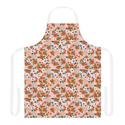 Floral Apron: A full-coverage kitchen apron featuring a soft pink backdrop adorned with orange and white flowers, accented by green leaves. Equipped with white neck and waist ties for a comfortable fit.