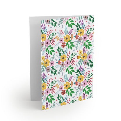 Floral Greeting Cards — Pack of 8/16/24, featuring hand-drawn wildflowers and greenery on a white background. The card is slightly open, revealing a blank inside, perfect for personalized messages.