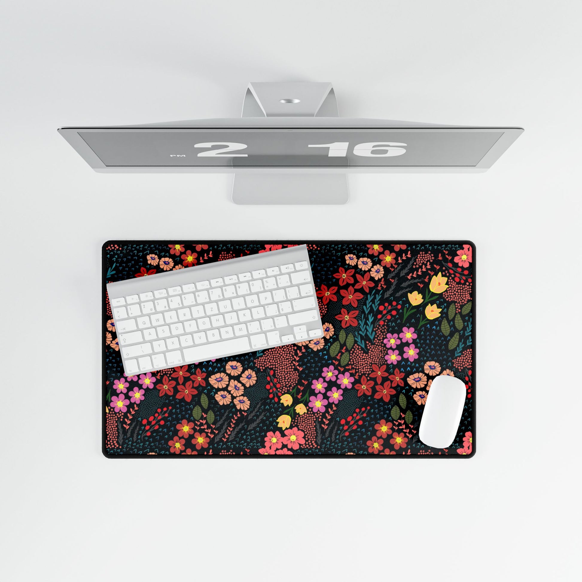 Desk Mat - Midnight Garden Floral Pattern, featuring a dense, colorful floral design, elegantly complements a minimalist setup with a white wireless keyboard and mouse, exuding modernity and vibrancy.
