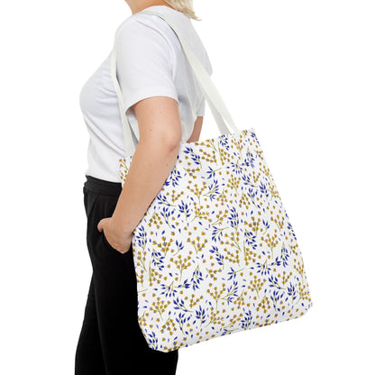A person carries the Wild Herb Garden Tote Bag, showcasing its botanical pattern of yellow and blue leaf sprigs. This durable, stylish tote is ideal for joyful summer outings.