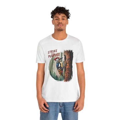 Woodpecker: Strike with a Purpose Bella+Canvas Unisex T-Shirt, featuring a vibrant woodpecker design. The man models this casual, motivational tee, perfect for nature lovers and those seeking inspiration.