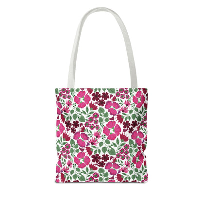 Pink Lady Tote Bag: A vibrant floral-patterned canvas tote with white straps, featuring pink and burgundy blossoms on a white background, perfect for adding a cheerful touch to everyday outings.