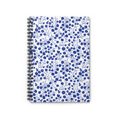 Floral Spiral Notebook featuring a white cover with a pattern of blue blossoms and butterflies, combining style and functionality for creative expression. Perfect for jotting notes or sketching ideas.