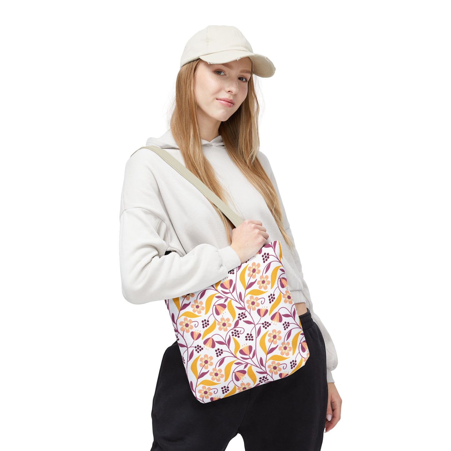Floral Tote Bag featuring a vibrant floral-and-vine pattern, worn by a young woman. Ideal for summer outings, it combines style with practicality, enhancing joyful, everyday adventures from FireBrook Designs.