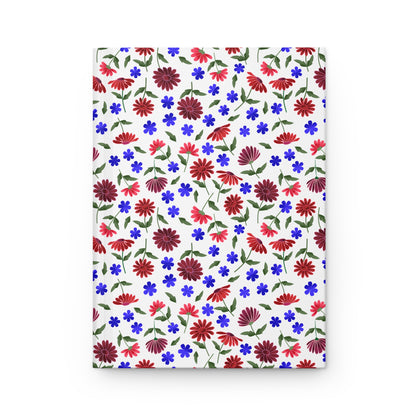 Floral Ditsy Hardcover Journal — Red & Blue Wildflower Notebook features a seamless floral pattern with red daisies and blue flowers on a white cover, embodying FireBrook Essentials' joyful, uplifting design ethos.