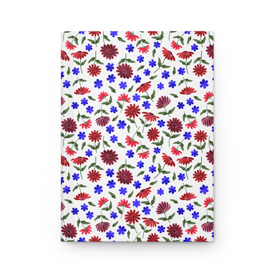 Floral Ditsy Hardcover Journal — Red & Blue Wildflower Notebook features a seamless floral pattern with red daisies and blue flowers on a white cover, embodying FireBrook Essentials' joyful, uplifting design ethos.