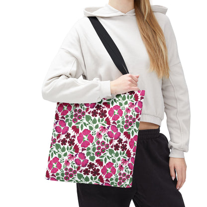 The Pink Lady Tote Bag showcases a vibrant floral pattern with pink, magenta, and burgundy blooms, perfect for adding a pop of color to everyday outfits.