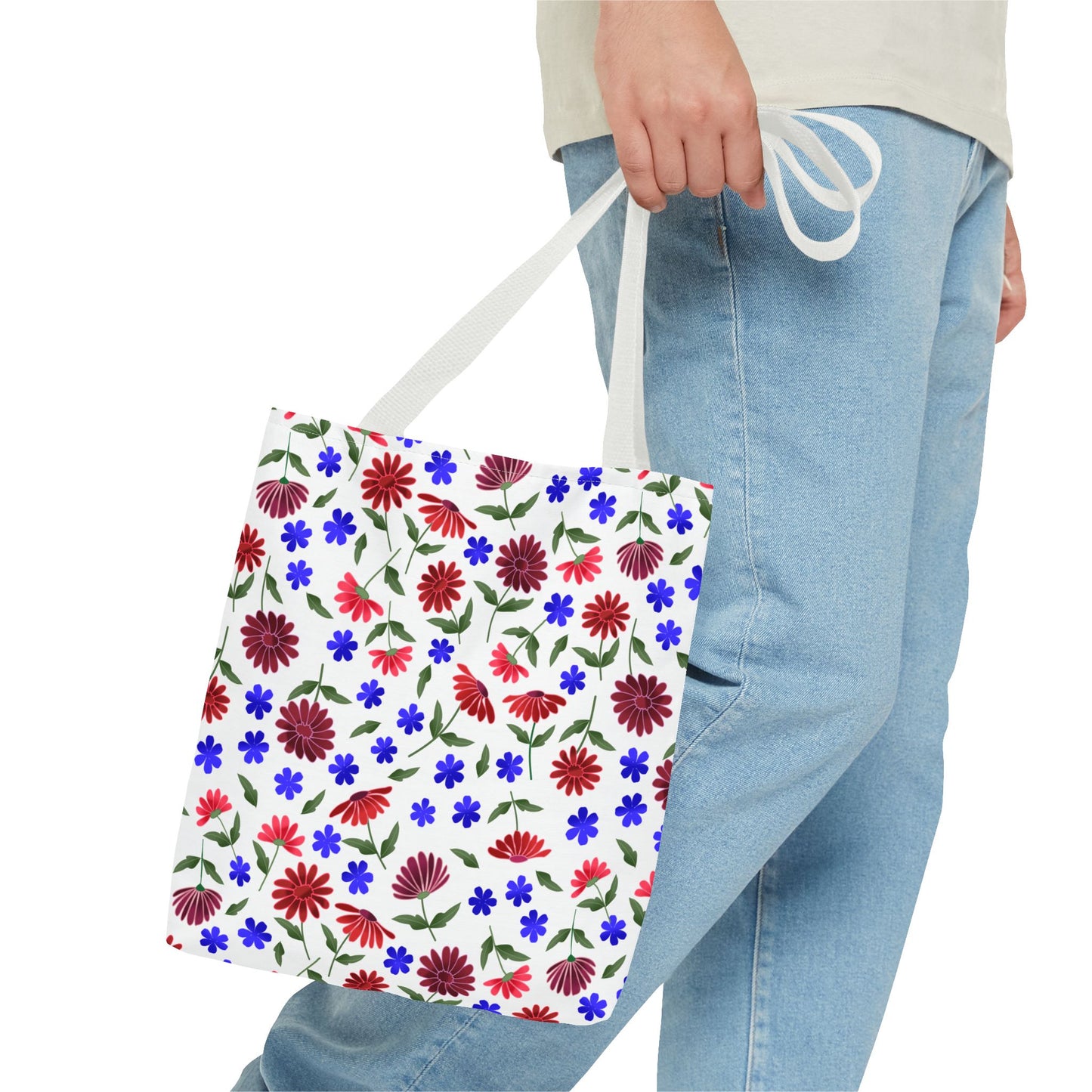 Floral Pattern Tote Bag — Red & Blue Wildflower All-Over Print: A white canvas tote with vibrant red and burgundy flowers, blue blooms, and green leaves, featuring black handles, ideal for daily use.