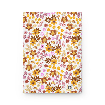 HARDCOVER JOURNAL, MATTE, RULED, 5X7, SEWN BIND, CLEAN-TEAR PAGES – RETRO BLOOM features a matte laminated cover adorned with a vibrant, autumnal floral pattern, complete with a small QR code in the corner.