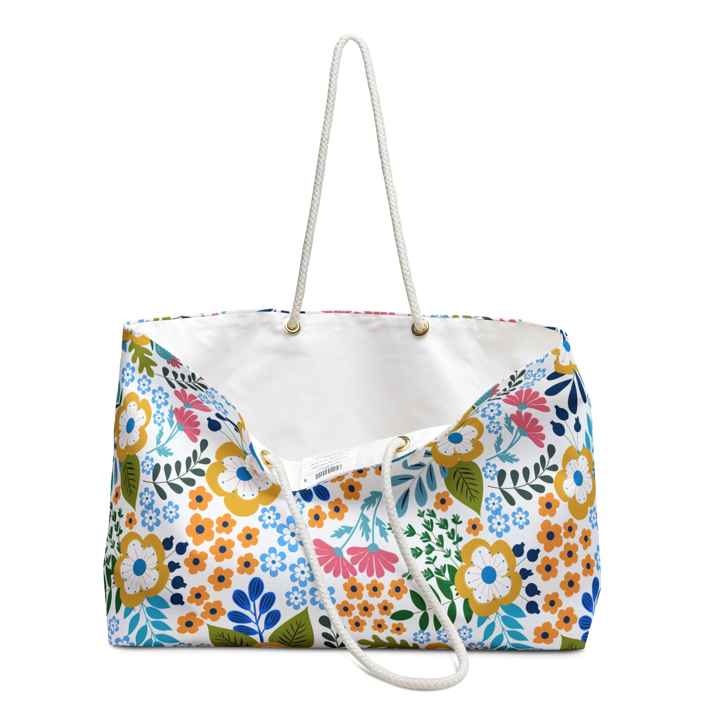 Weekender Bag with rope handles features a bright floral pattern on canvas, ideal for stylish travel. Its roomy design and luxurious cream interior make it perfect for beach trips or everyday use.
