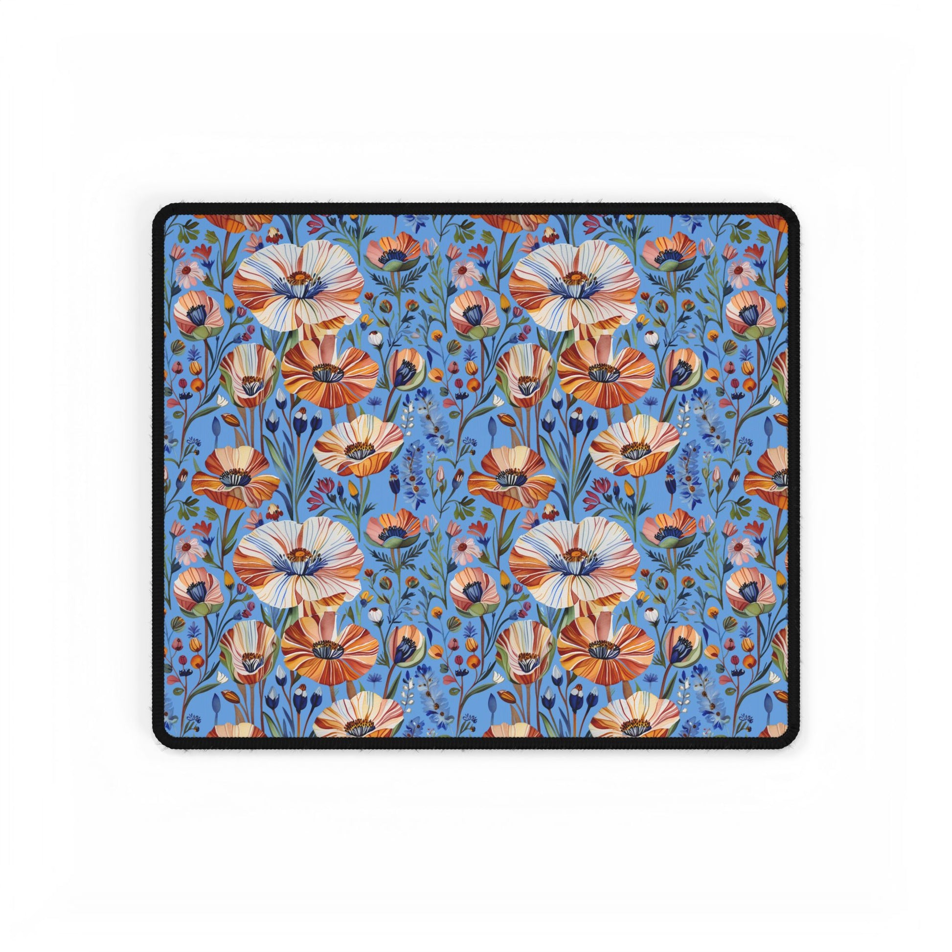 Desk Mats - Spring Wildflowers Poppy Cornflower Iris Design features a vibrant wildflower pattern with orange, cream, and pink blooms on a blue background, bordered in black, ideal for enhancing any workspace.