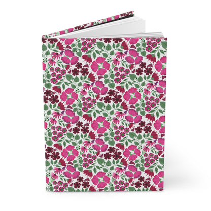 HARDCOVER JOURNAL, MATTE, RULED, 5X7, SEWN BIND, CLEAN-TEAR PAGES – ROSE GARDEN features a floral cover with pink and burgundy blossoms. The journal's open pages reveal its clean, blank lined sheets.