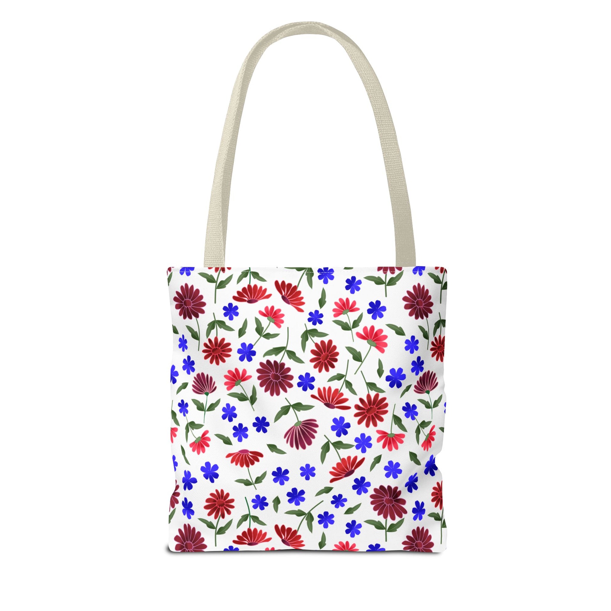 Floral Pattern Tote Bag — Red & Blue Wildflower All-Over Print features vibrant daisies and blue flowers on a white canvas, with black handles. Perfect for carrying everyday essentials with a joyful, cottage charm.