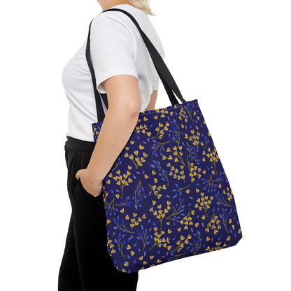 Floral Tote Bag with a navy-blue body and yellow-blue botanical print, featuring long black straps, ideal for summer outings. Stylish and durable, embodying FireBrook Designs' uplifting aesthetic.