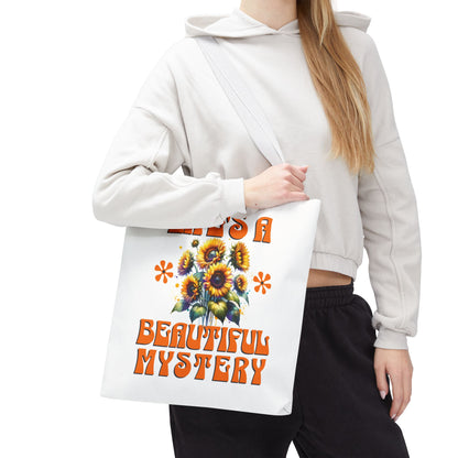 Life's A Beautiful Mystery Tote Bag featuring sunflower print, held by a woman, embodies wonder and intrigue, ideal for daily adventures and gifting.