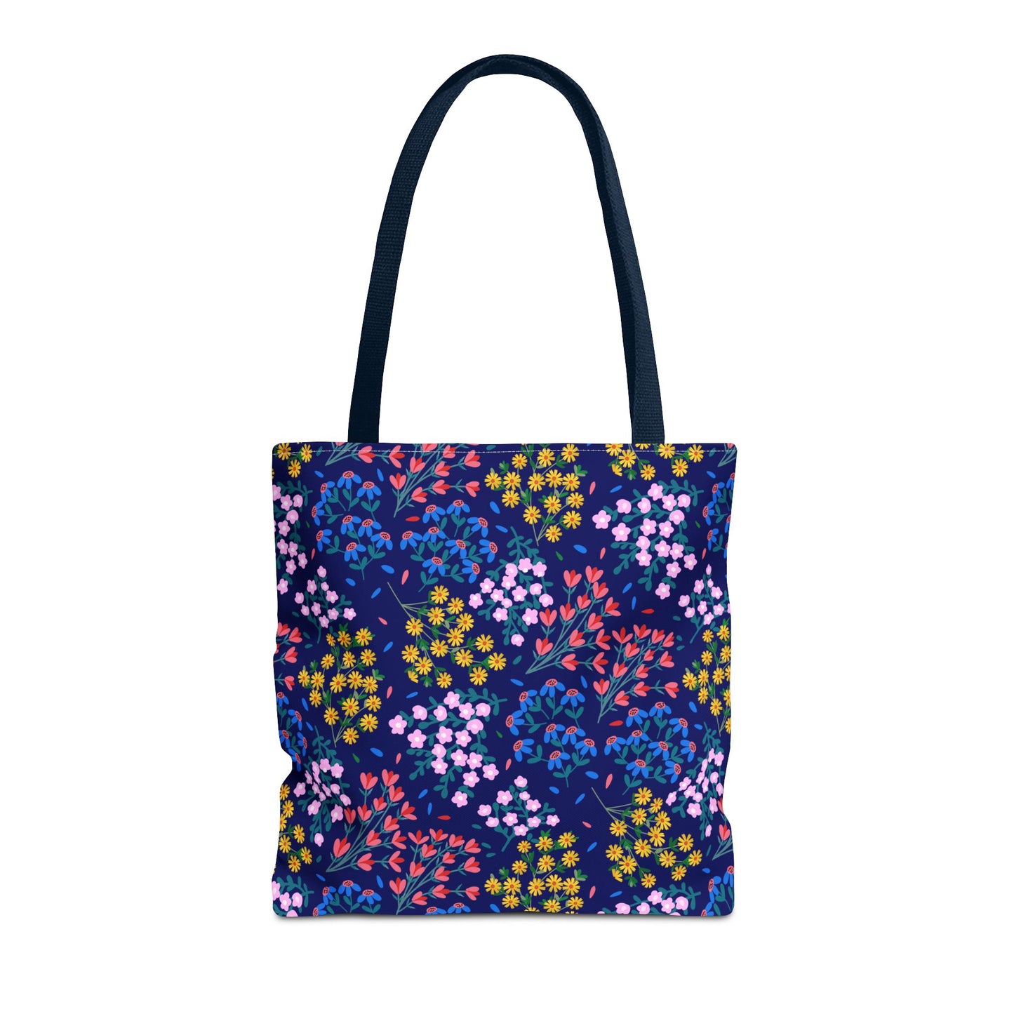 Midnight Garden Tote Bag: A stylish, navy canvas tote with a vibrant floral print featuring yellow, pink, red, and blue flowers. Reinforced dark handles make it perfect for carrying over the shoulder.
