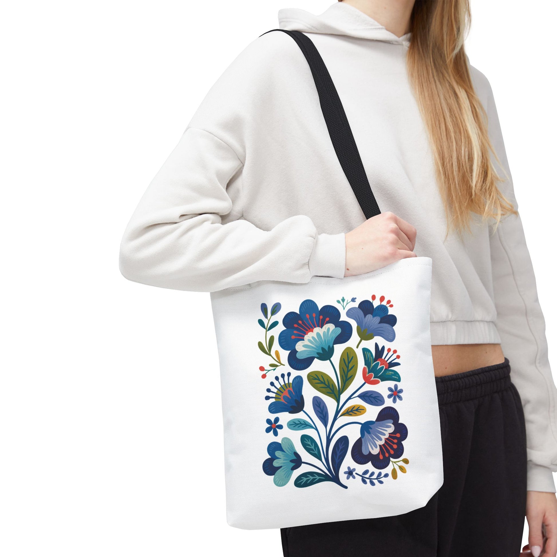 Vintage Folk Art Design Blue Floral Tote Bag featuring a charming, nostalgic blue floral pattern. Ideal for everyday use or special occasions, it embodies unique style with reinforced handles and a durable polyester body.