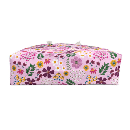 The Weekender Bag showcases a vibrant red bouquet design, featuring rope handles and a cream interior. Perfect for stylish travel, embodying FireBrook Essentials' commitment to joyful, uplifting design.