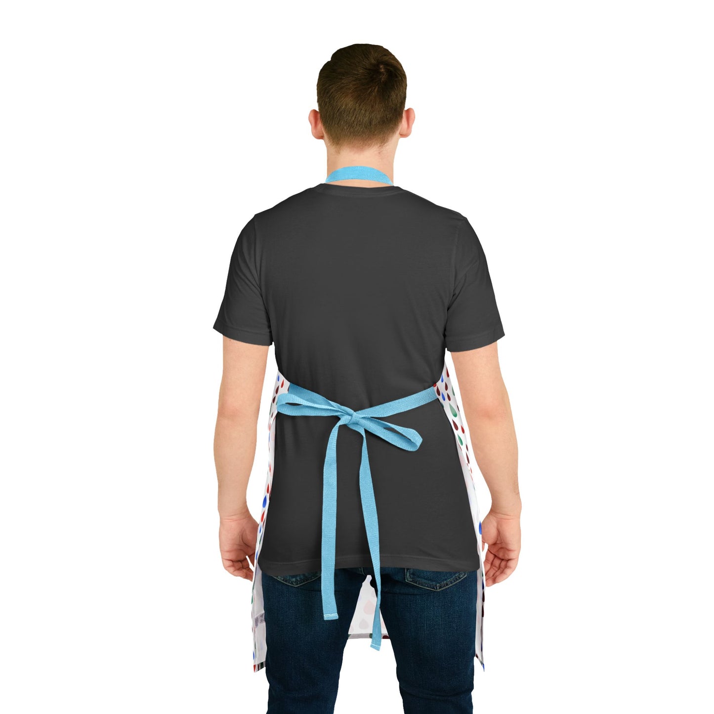 Happy Raindrops Apron on a person wearing a dark t-shirt and jeans, featuring multicolored polka-dots and light blue straps tied in bows, embodying comfort and style from FireBrook Essentials.