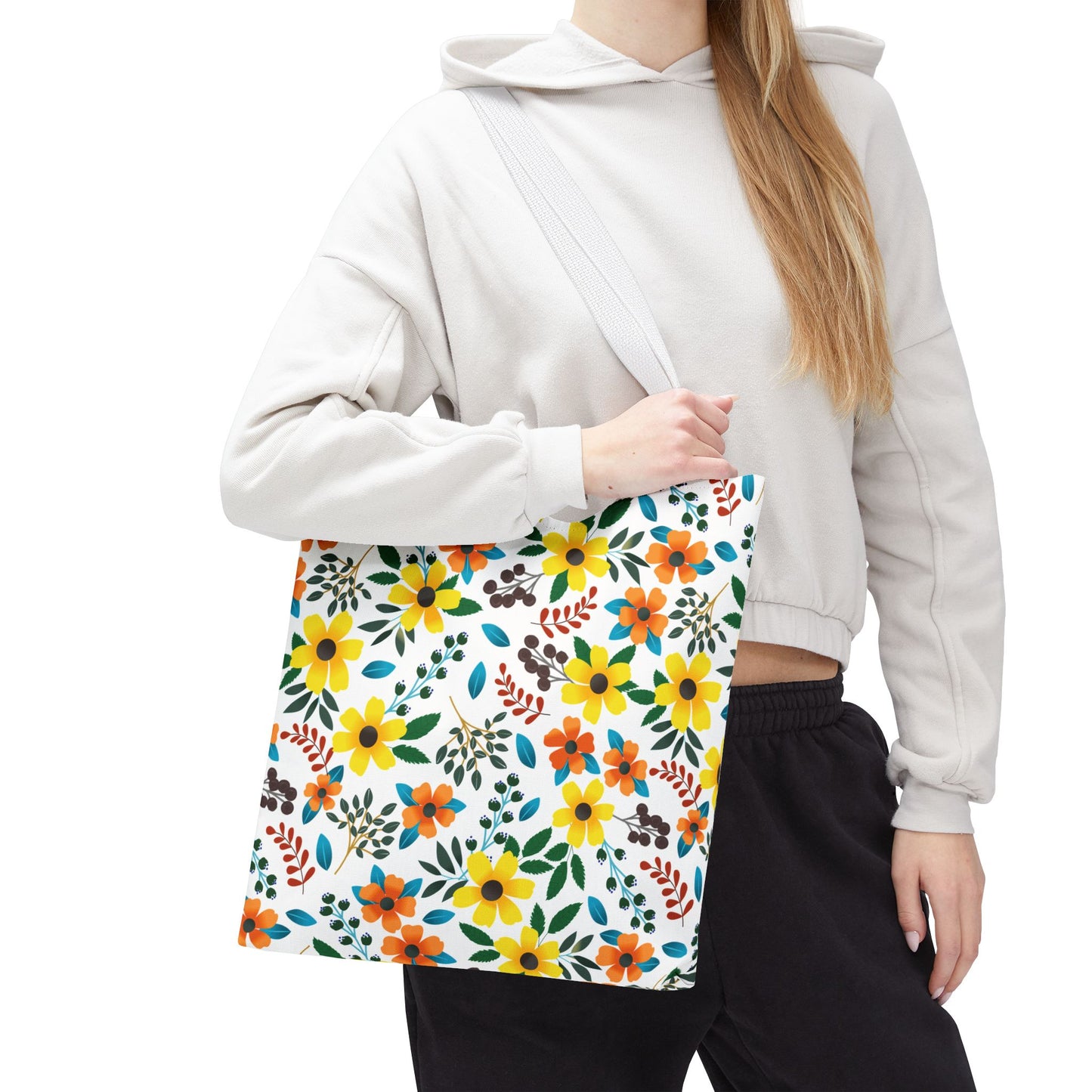Floral Tote Bag with vibrant yellow and orange blossoms, ideal for summer outings. Durable with a 100% polyester body, reinforced handles, and boxed corners for extra room, reflecting FireBrook Designs' joyful style.