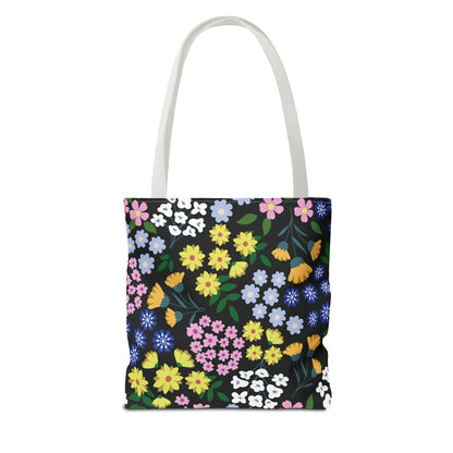 Starry Night Blooms Tote Bag features a vibrant floral pattern on a black background, white straps, and boxed corners for extra space, embodying FireBrook Designs' stylish and joyful aesthetic.