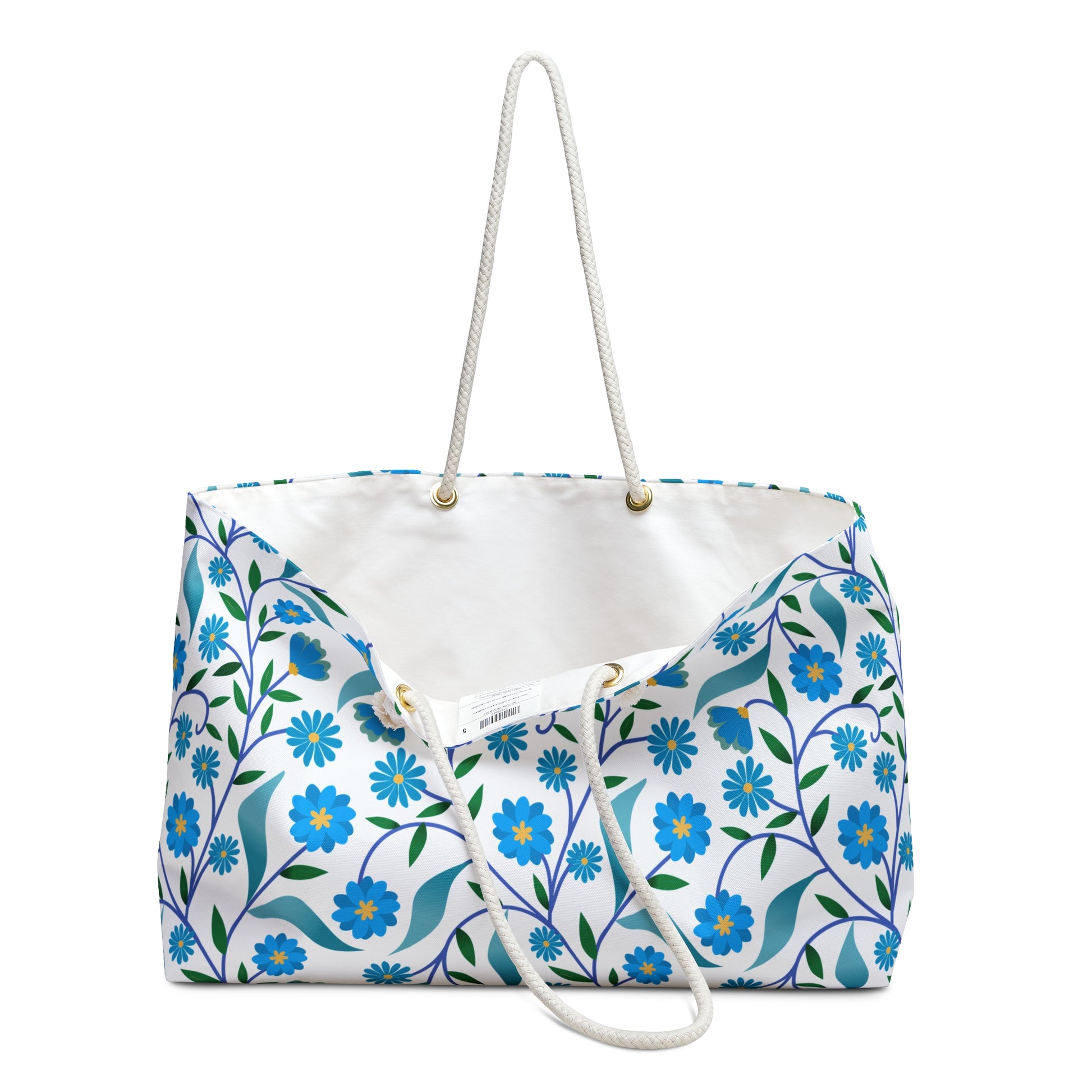 Weekender Bag with rope handles, featuring a blue floral and green leaf pattern on a white background, exemplifies FireBrook Designs' stylish, joyful essentials for effortless travel.