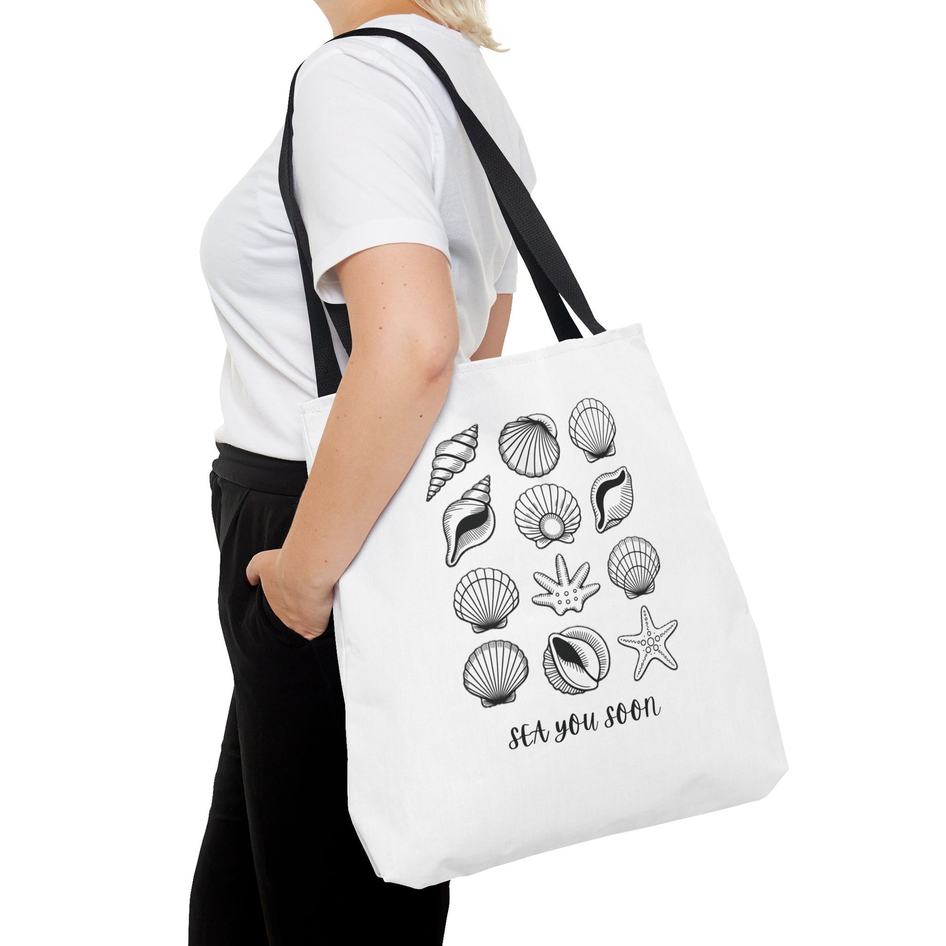 Sea Shells Tote Bag with a beachy design, showcasing durable polyester fabric and reinforced stitching, ideal for seaside trips. Available in multiple sizes, perfect for carrying essentials on sunny outings.