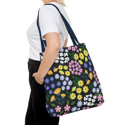 Person carrying a Floral Tote Bag with a vibrant floral pattern and navy straps, ideal for summer outings. The bag showcases FireBrook Designs' commitment to stylish, joyful, and practical accessories.