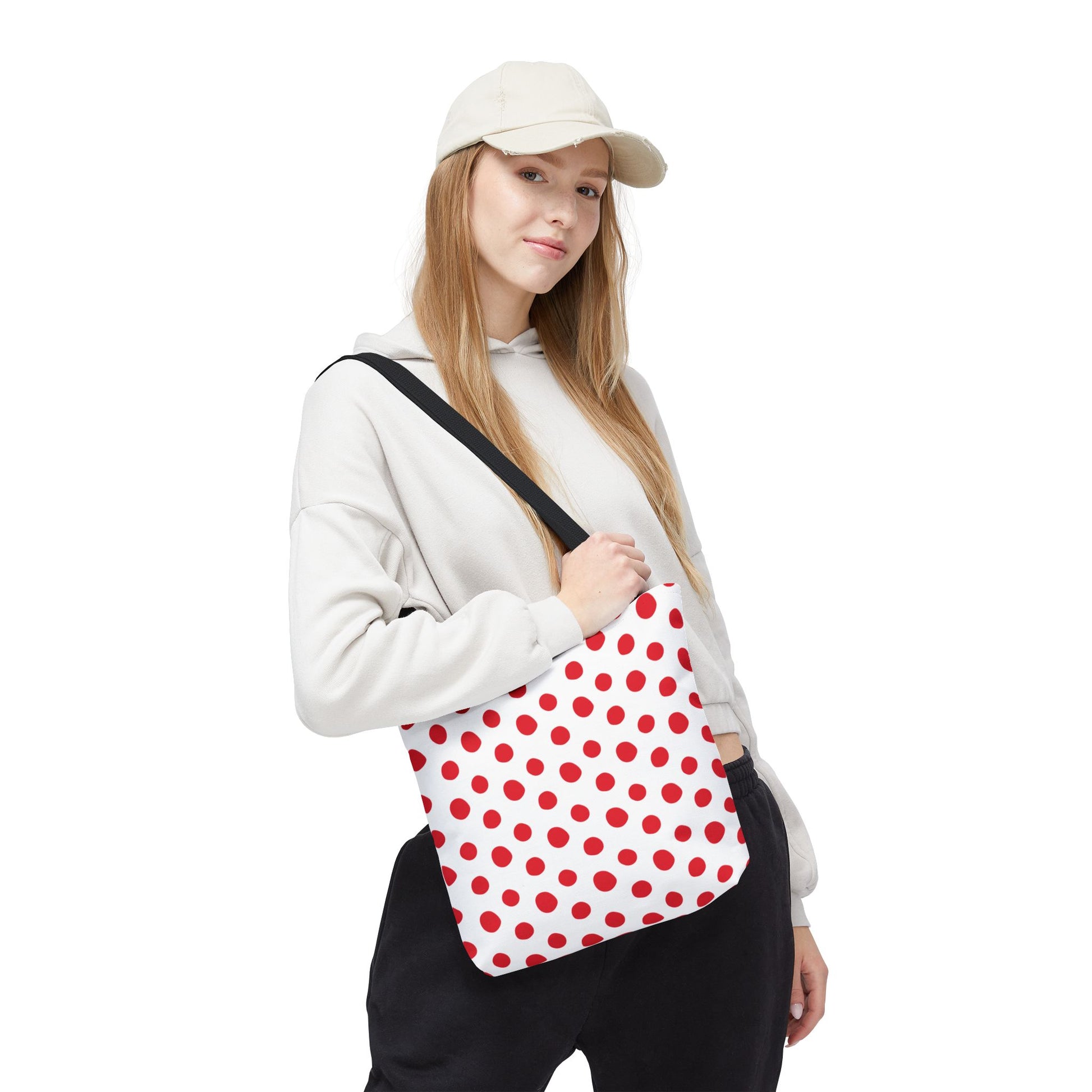 Red Polka Dots Tote Bag, showcased up-close with a hand holding its strap, embodies a vibrant, playful design ideal for everyday use, reflecting FireBrook Essentials' commitment to stylish, uplifting accessories.