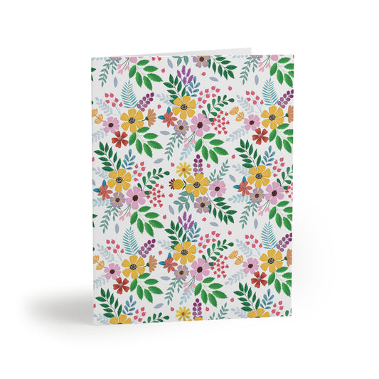 Floral Greeting Cards — Pack of 8/16/24 featuring a vibrant, hand-drawn wildflower pattern on a crisp white background, embodying cheerful, springtime energy. Each card includes a matching white envelope, perfect for personal messages.