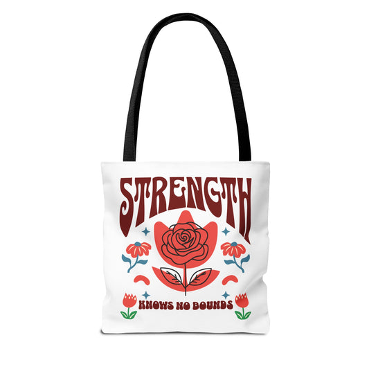 Strength Knows No Bounds Tote Bag featuring red and blue text and a red flower design. Durable polyester body with reinforced handles, ideal for everyday use. Available in various sizes.